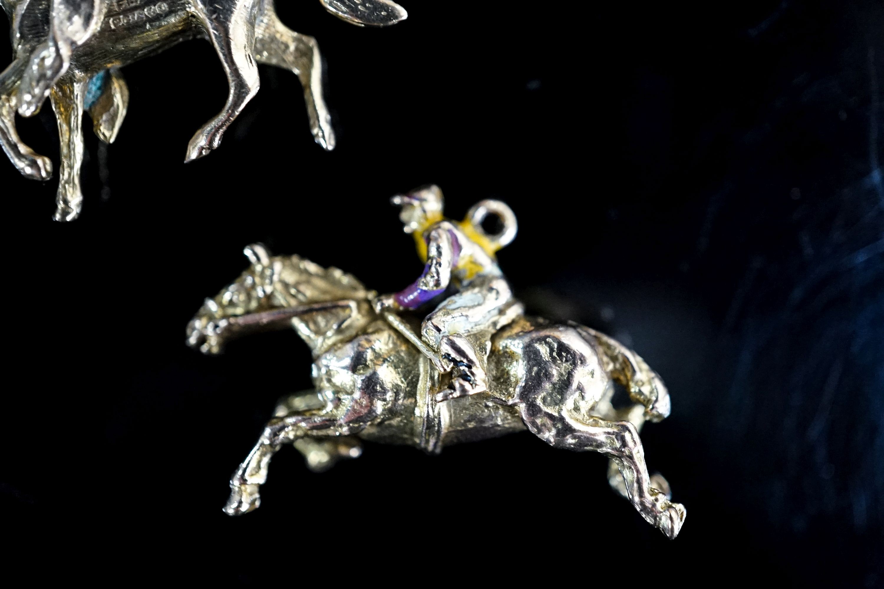 Two 9ct gold horse pendant charms including enamelled horse and jockey(a.f.), 33mm, gross 14.7 grams.